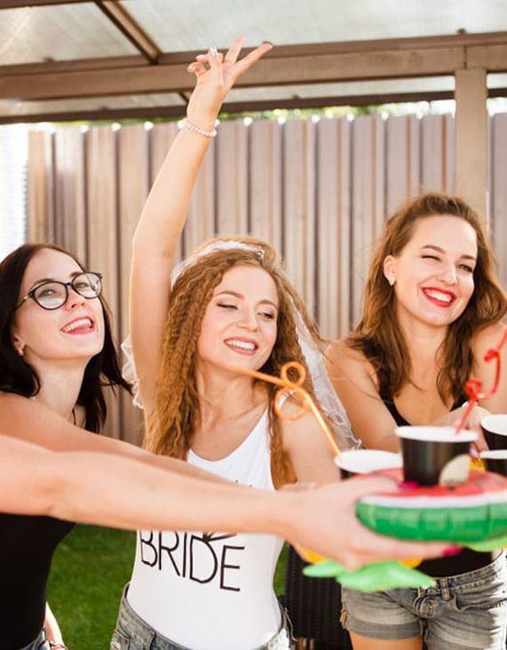 bridesmaids holding out drinks