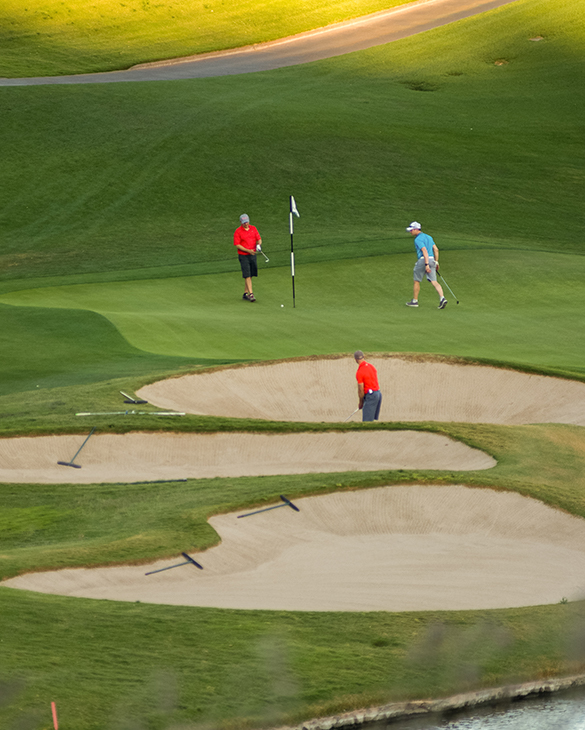 overhead view of people walking around golf course