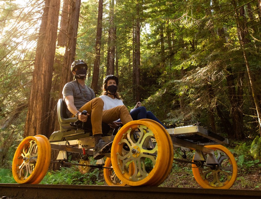 couple on a railbike in the woods
