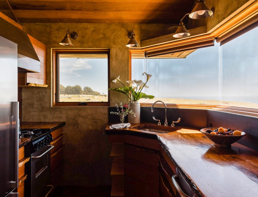 kitchen area with windows overlooking the water in the distance