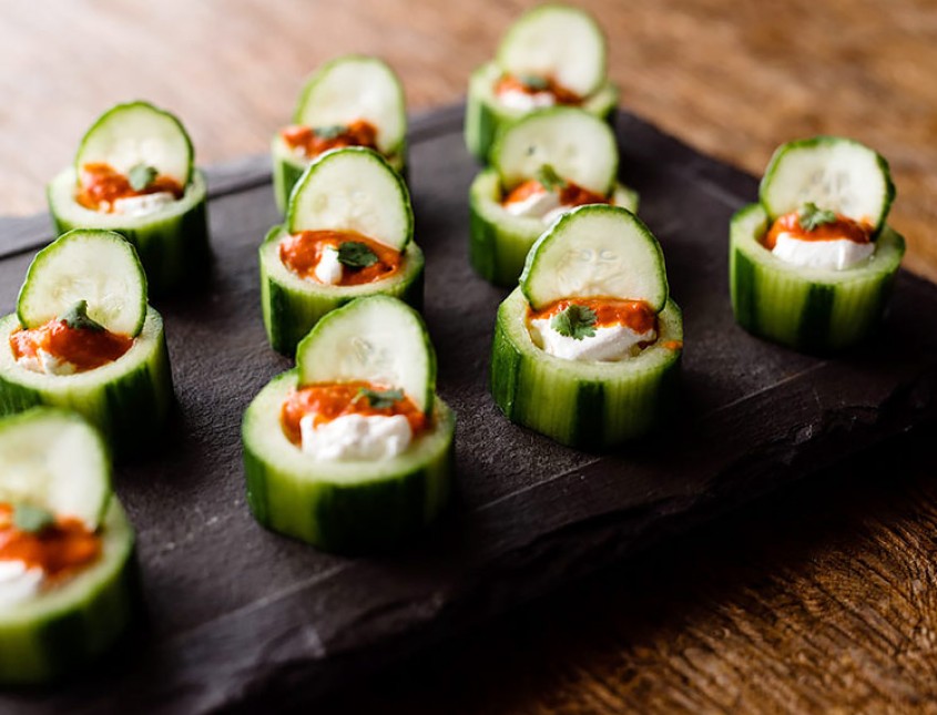 appetizer catering plate with zucchini, cheese, and red sauce