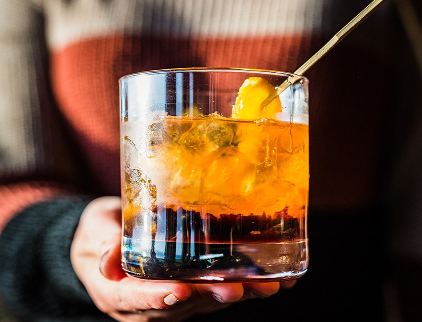 cocktail drink with orange slice garnish