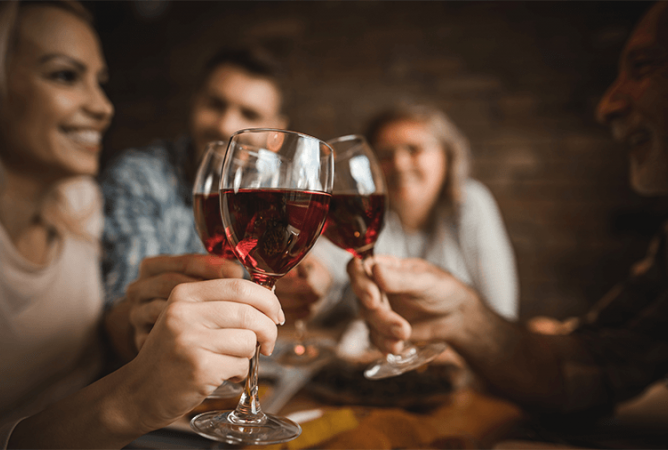 group of friends clinking wine glasses together
