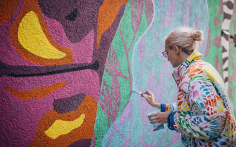 woman painting a mural