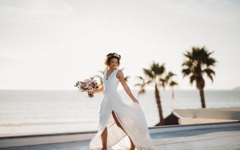 a woman on the beach in a wedding dress