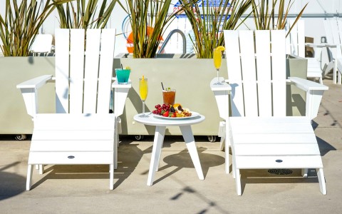 white lawn chairs with plate of food