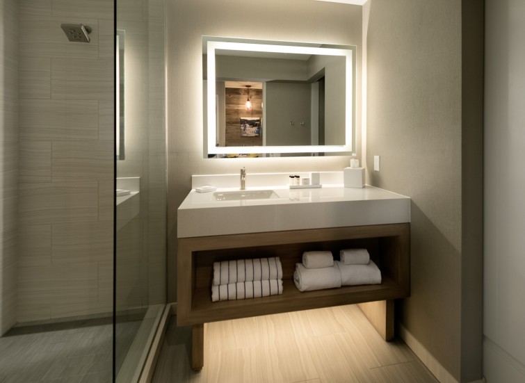 a guest bathroom with a light-up vanity