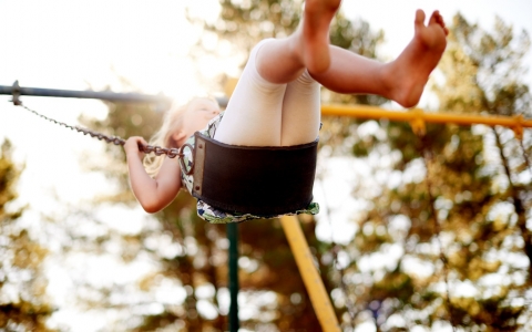 Girl swinging on a swing