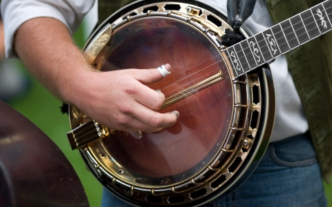 Close up of a man playing the banjo