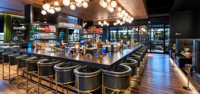  A large square bar with blue and gold chairs with cool round lights