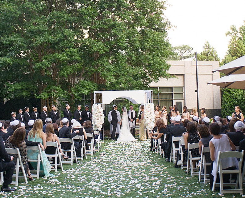outdoor wedding ceremony with a trail of white roses