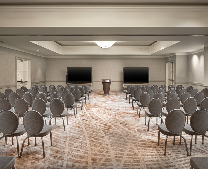 conference room with 2 large screens and podium set at the front