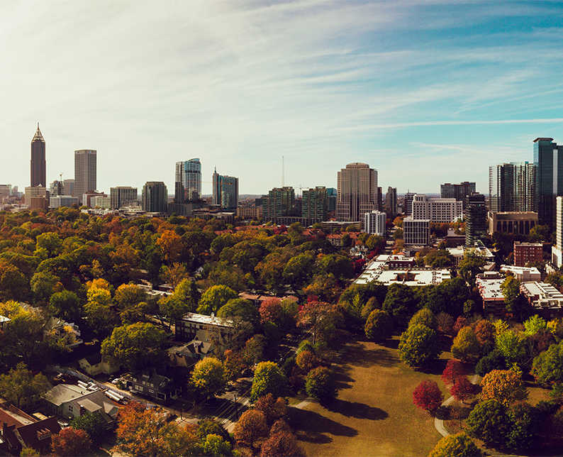 the city of atlanta, georgia on a sunny day with trees and buildings