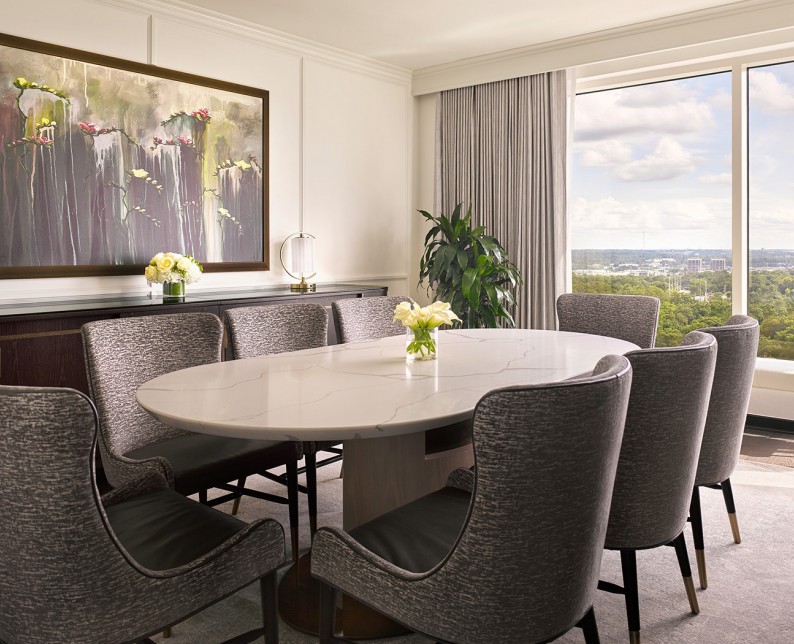 grey chairs surrounding a dining table