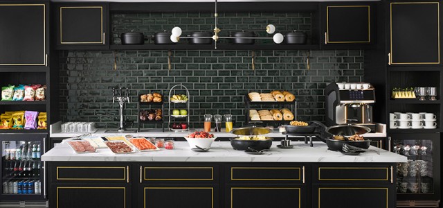 kitchen with dark panels and food on an kitchen island