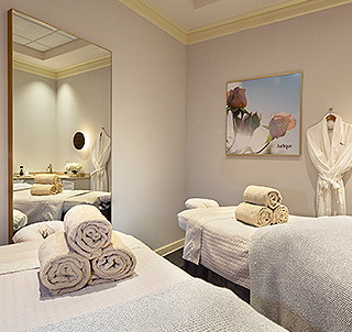 white massage table with towels in a treatment room