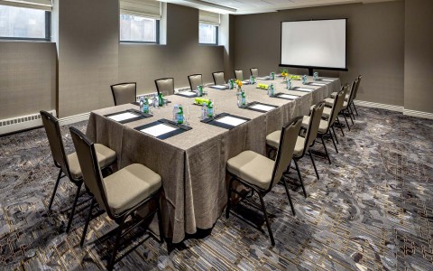 meeting space with a long desk and display
