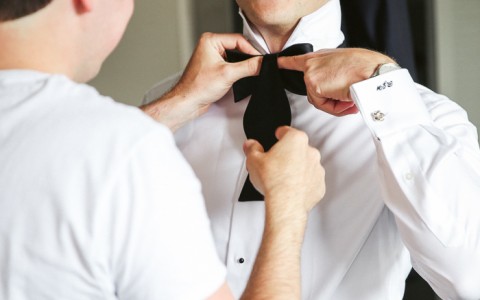 groom gets his bowtie put on