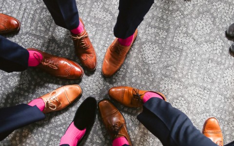 groom and groomsmen put their shoes in a circle