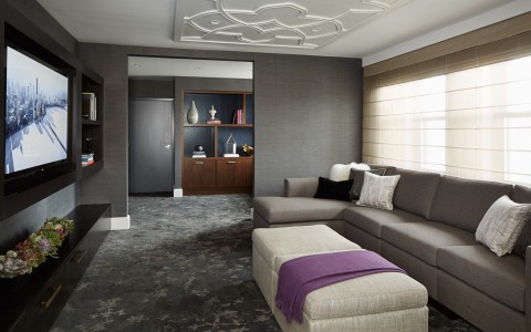 huge living room space with a couch, foot rest, and tv