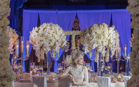 bride posing in front of beautiful wedding decor