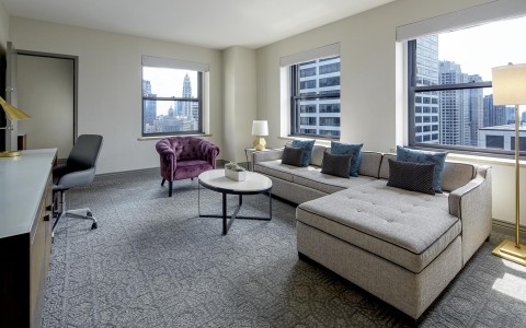 living room space with a large couch and view of the city
