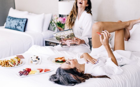 two women enjoying room service