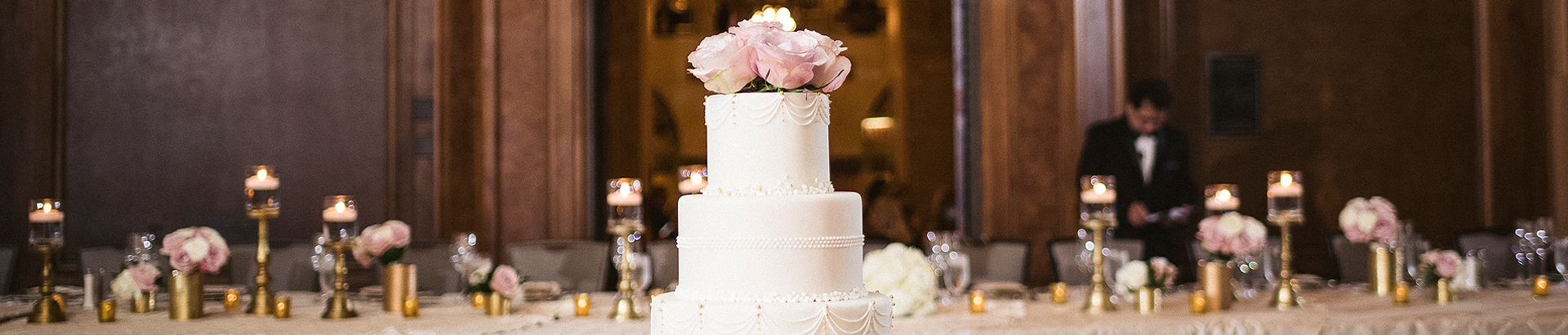 wedding cake in front of a large table