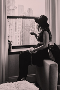 lady looking out the window at the skyline
