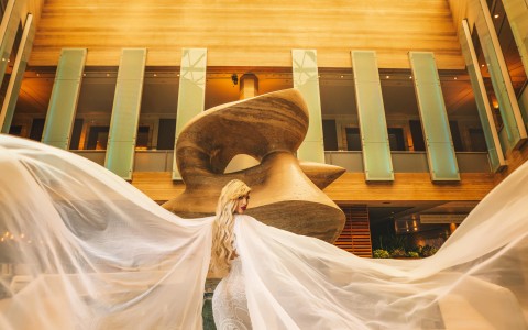 a bride in the lobby with her wedding dress on, posing for the camera