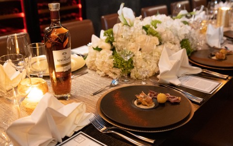 a table set up with white flowers, silver and white theme decor and silverware. for the Macallan event held on property. 