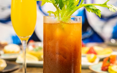 a bloody mary drink and a mimosa drink side by side