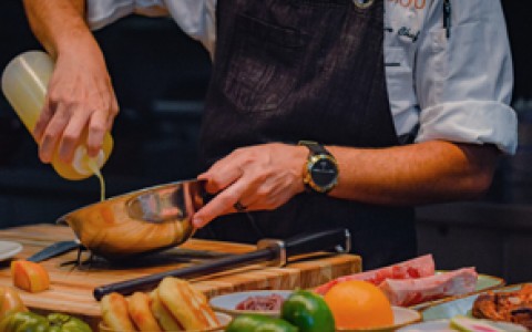 a chef mixing something in a bowl
