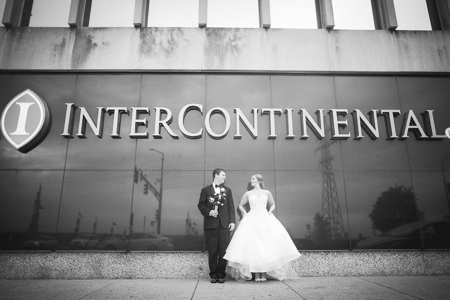 bride and groom in front of the intercontinental saint paul riverfront sign