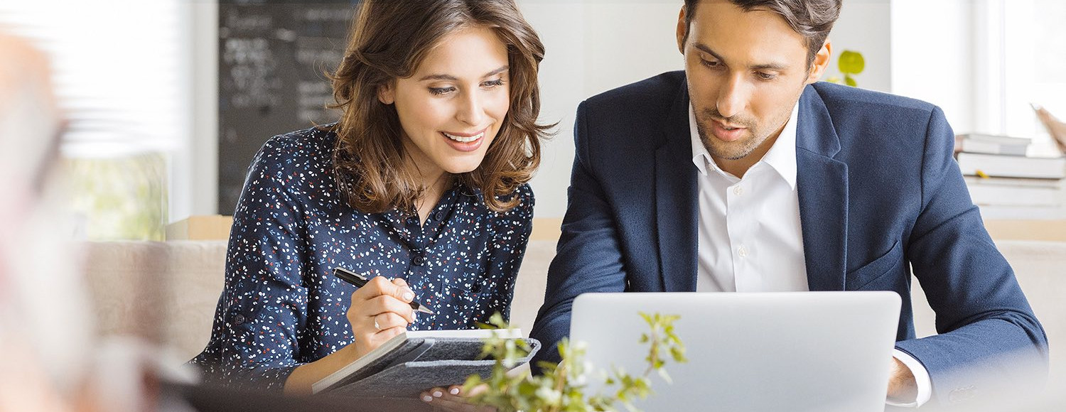man and woman working on laptops