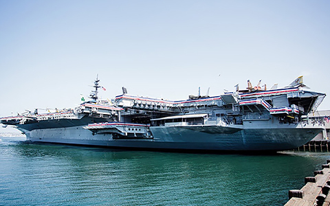 A big naval war ship at a dock