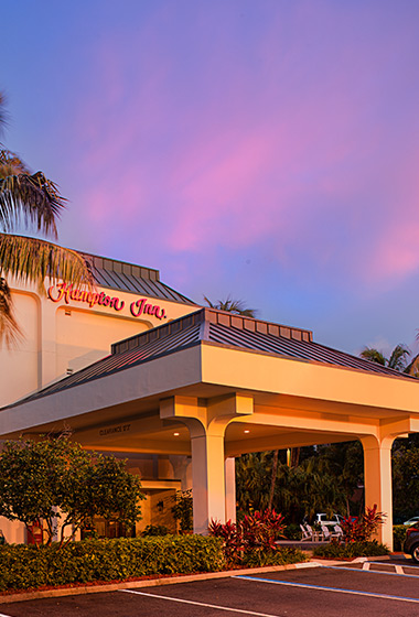 exterior of hotel with a purple sky behind 
