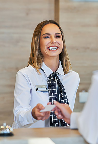 woman at front desk checking in guest