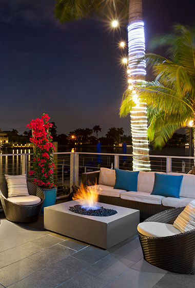 rooftop lounge area with couches and fire pit