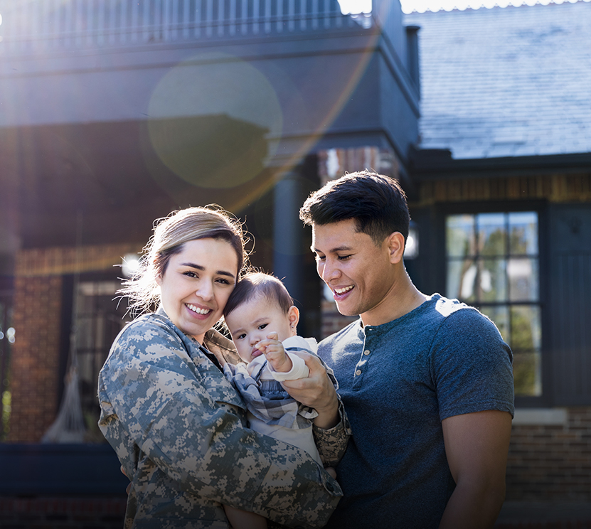 woman in the military hugging her family