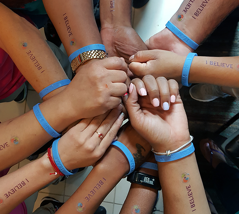group of handds with blue writbands