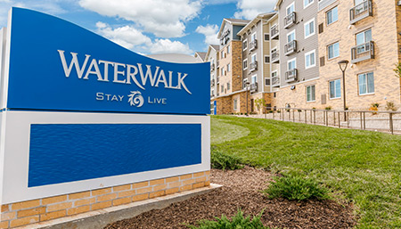 blue and white sign that says Waterwalk