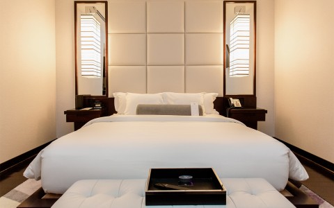 A large bed with two bright lights on each side.