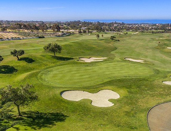 aerial view of the golf course and the ocean during the day