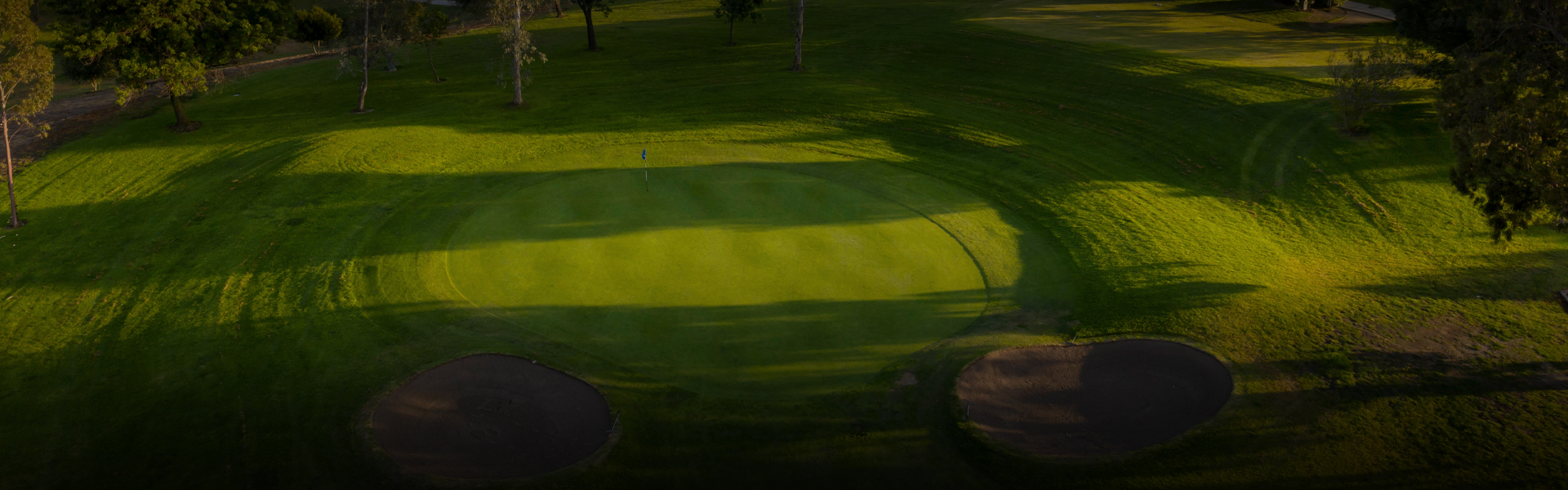 aerial view of the golf course with the sun setting to the right