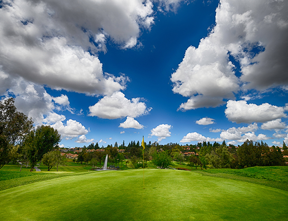 bright blue skies and lots of clouds over the golf course