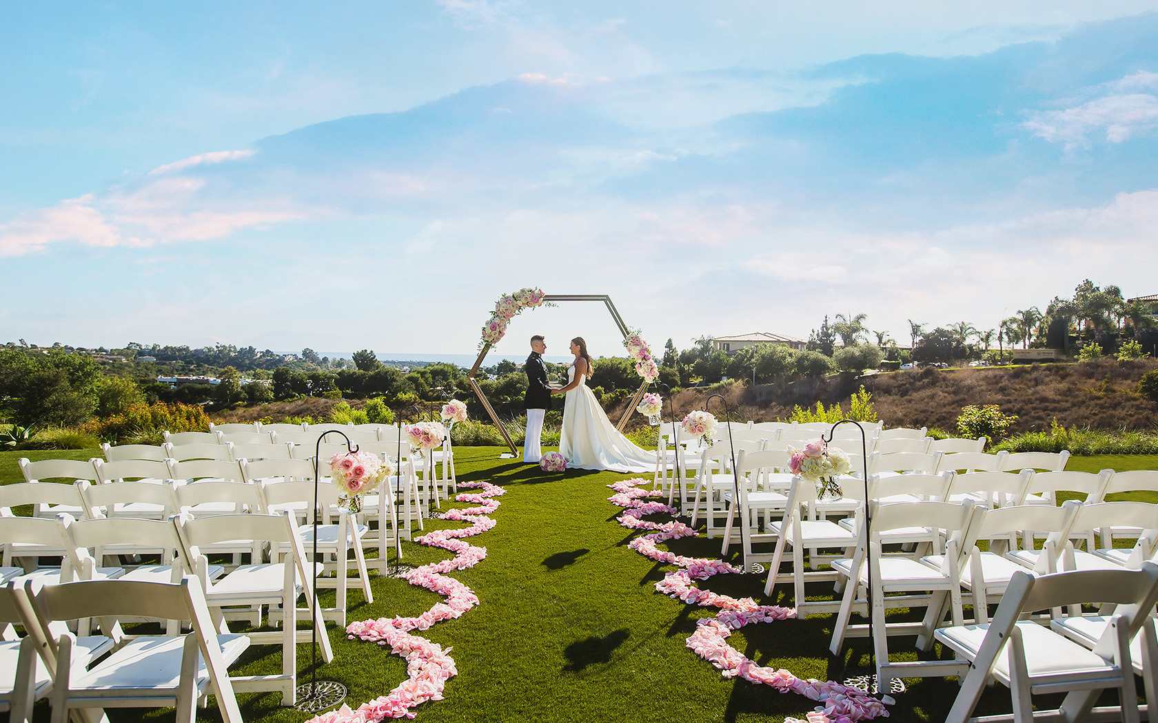 an outdoor wedding with a bride and a groom during the day