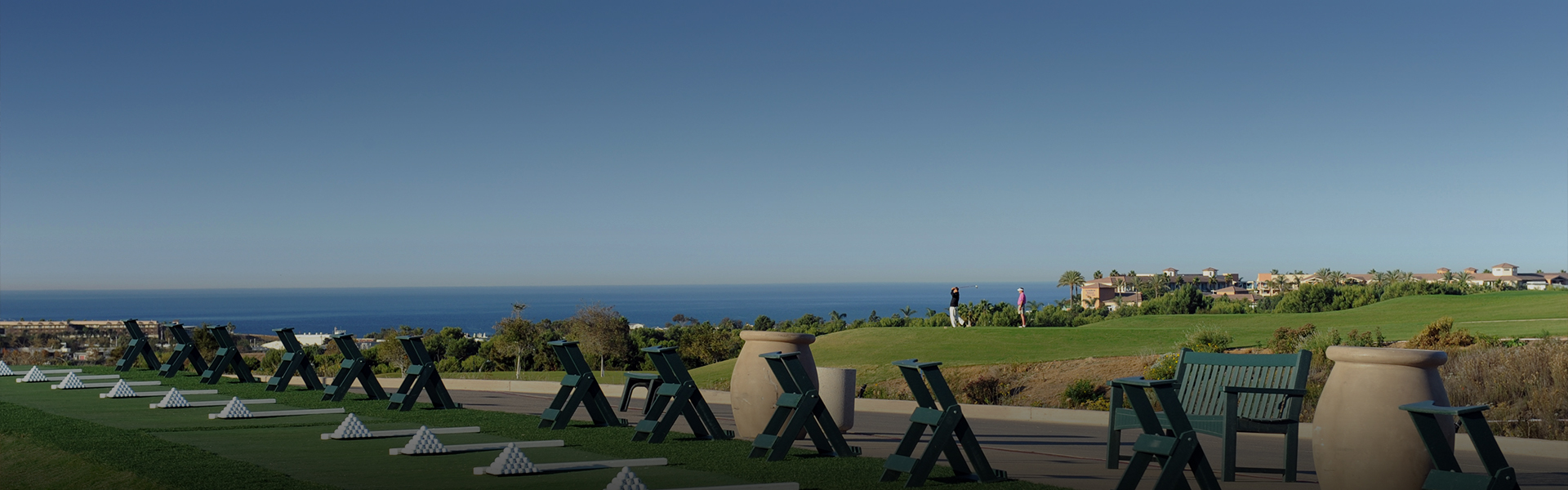panoramic view of the driving range and the ocean in the far distance