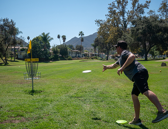 a man playing disc golf on a sunny day
