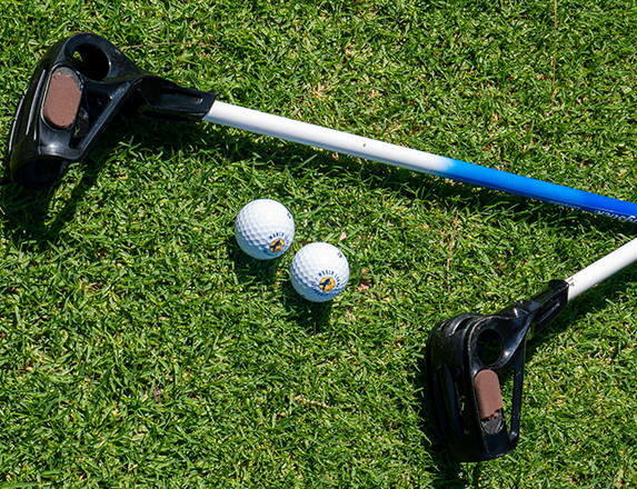 a close up of two golf clubs and two golf balls